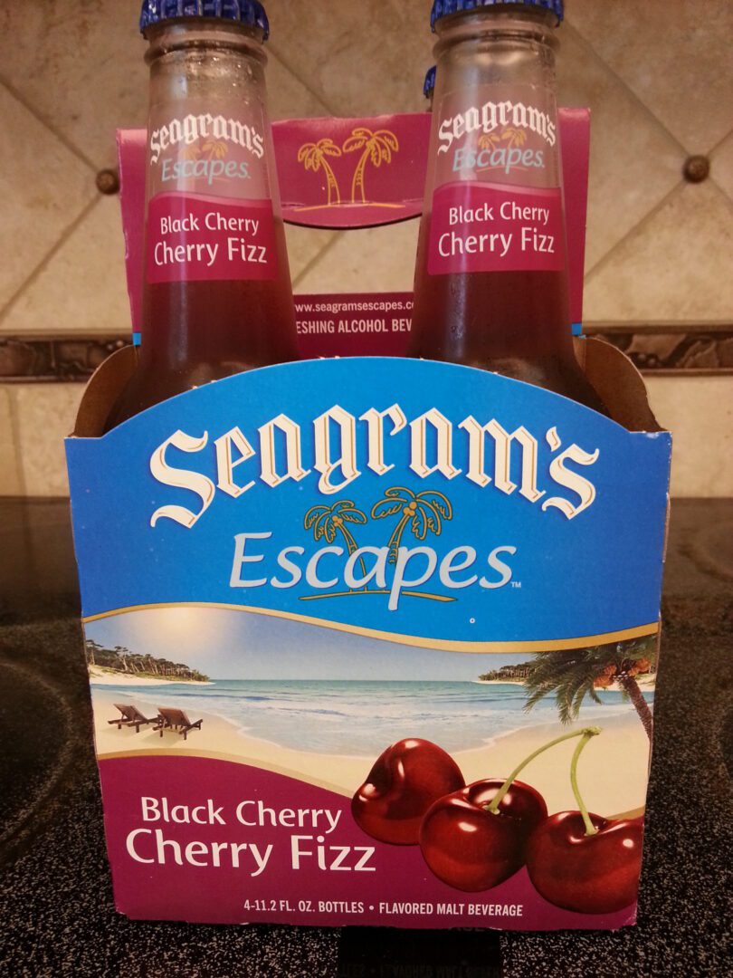 A bottle of black cherry cherry fizz sits on the counter.