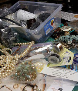 A table full of various items and beads.