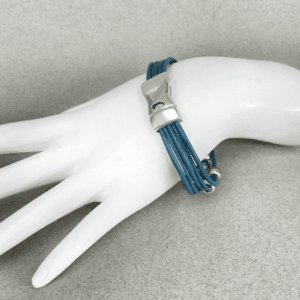 A white hand is holding something blue