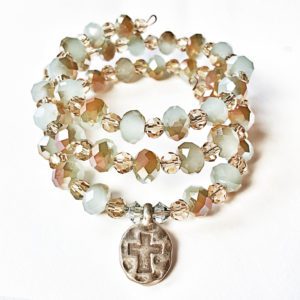 A bracelet with a cross charm and beads.