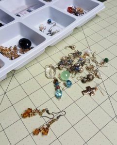 A table with many different types of earrings.