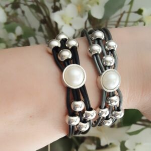 A pair of bracelets with pearls on them.