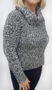 A woman wearing a black and white sweater.
