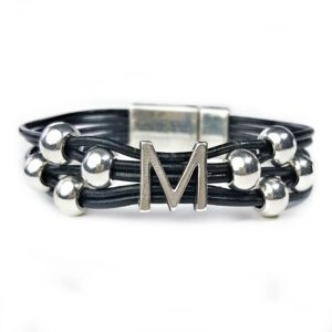 A black leather bracelet with silver beads and an initial.