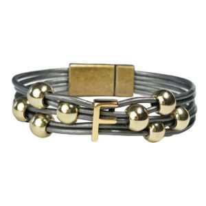 A bracelet with gold beads and an initial.