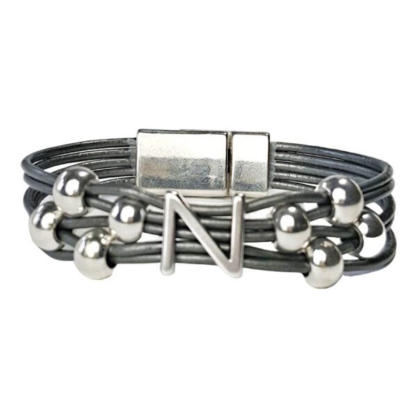 A gray leather bracelet with silver beads and an initial.
