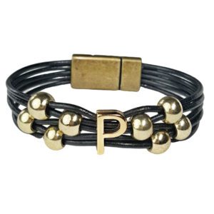 A black leather bracelet with gold beads and an initial.