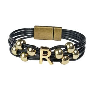 A leather bracelet with gold beads and an initial.