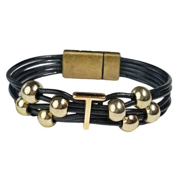 A black leather bracelet with gold beads and an initial t.