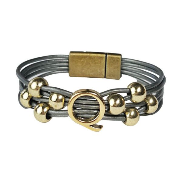 A gray and gold bracelet with a metal ring.