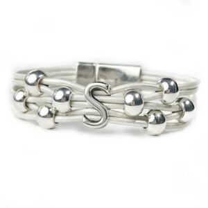 A silver bracelet with the letter s on it.