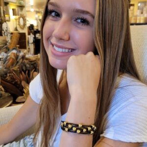 A girl with long hair and wearing a bracelet.