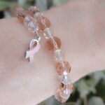 Breast Cancer Bracelet made with Austrian crystals on memory wire accented with silver trimmed ribbon charm.