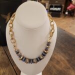 Picture of a chunky necklace on a neck display stand. Shows its colors and size.