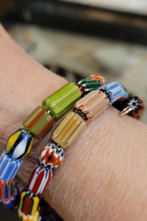 A close up of two bracelets on someones wrist